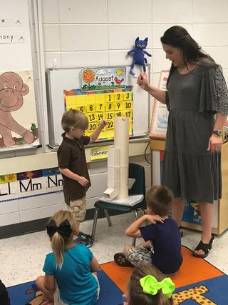 Image of Teacher with Children playing with Itsy Bitsy Spider Water Spout